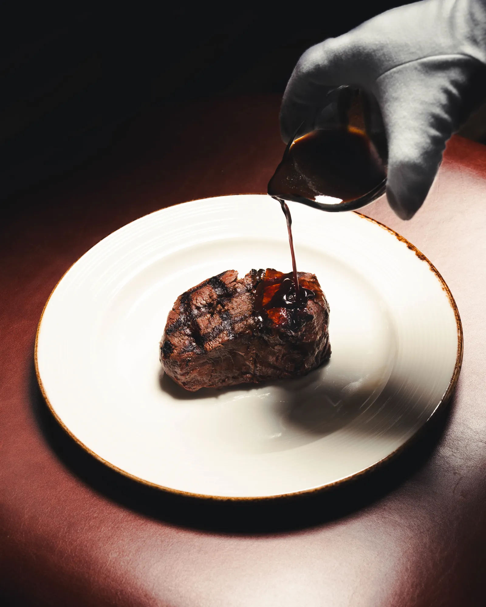 Jus is poured over a grilled fillet